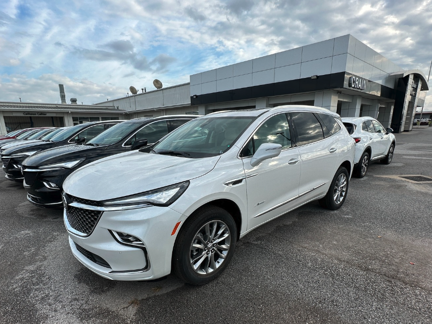 White Buick SUV parked at Crain Buick GMC in Springdale, Arkansas, alongside a row of other vehicles
